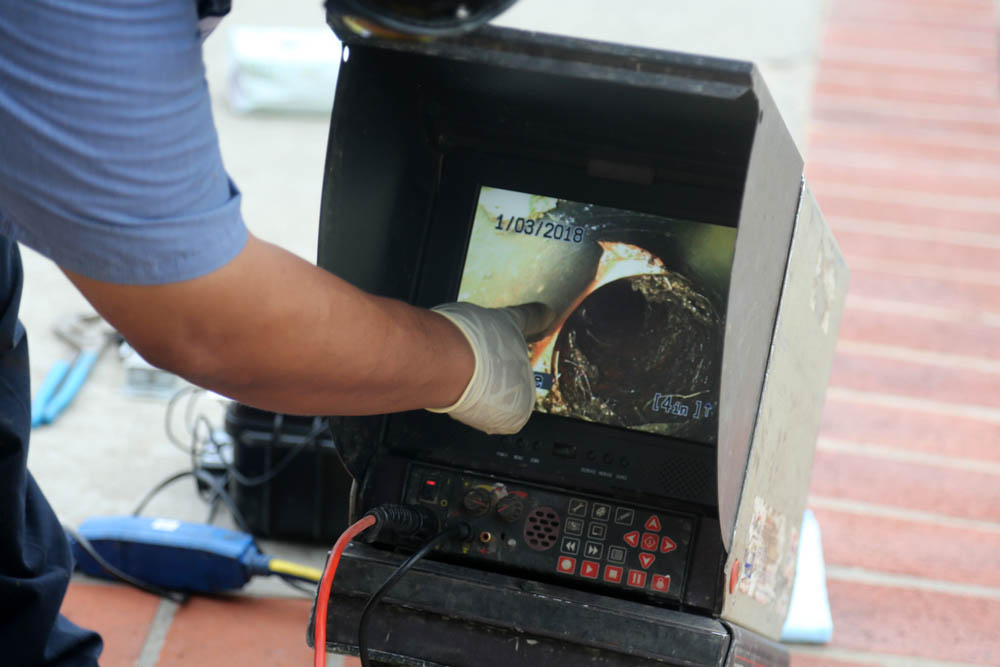 Technician monitoring a sewer video feed